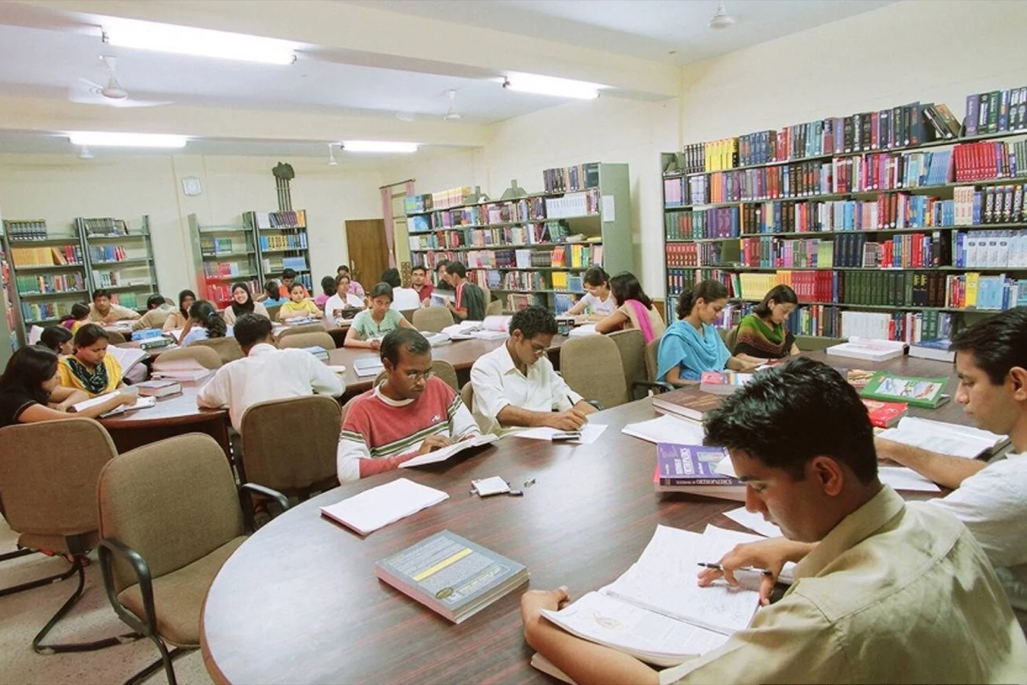 Students participating in sports competition with athletic track in background